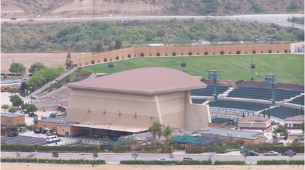 Coors Amphitheatre viewed from a distance, showcasing its distinctive architecture and surrounding landscapes.