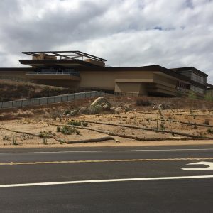 Hollywood Casino Jamul viewed from the roadside, showcasing its modern architecture against a partly cloudy sky.